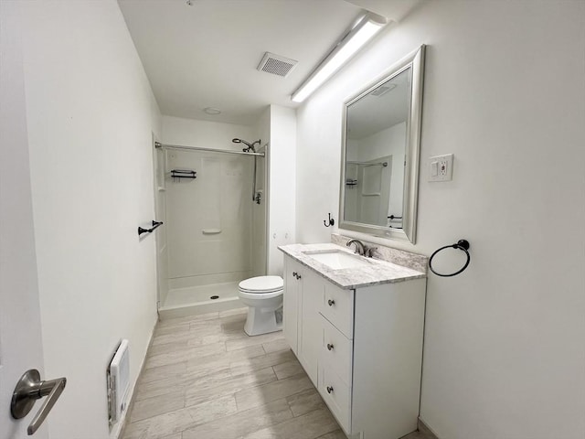 full bathroom with visible vents, toilet, vanity, and walk in shower