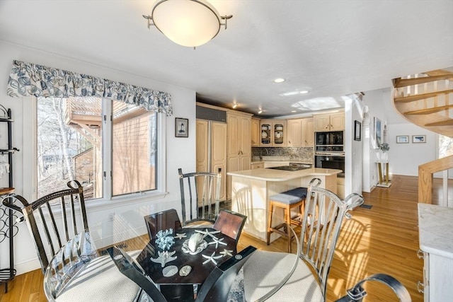dining area with recessed lighting, light wood-style floors, stairway, and baseboards