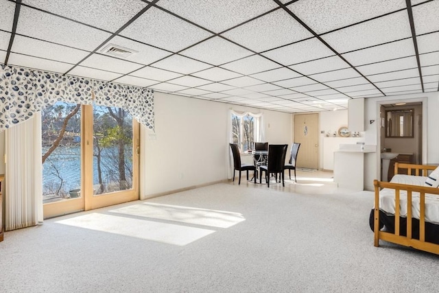 bedroom with carpet floors, visible vents, and a drop ceiling