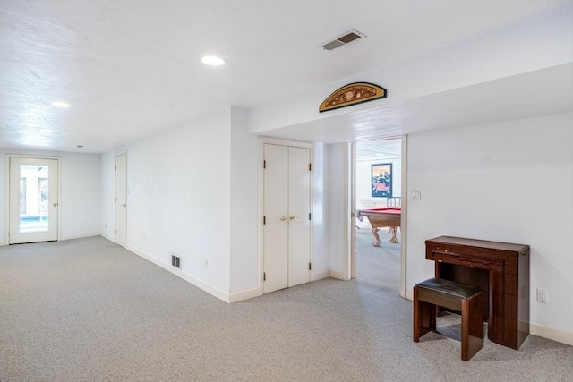 corridor with light colored carpet, baseboards, visible vents, and recessed lighting