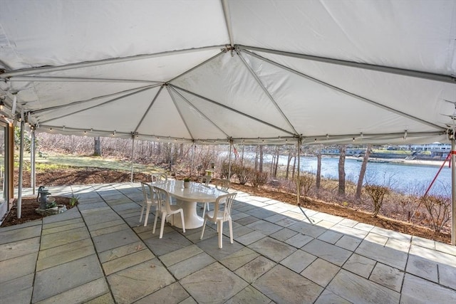 view of patio featuring outdoor dining space and a water view