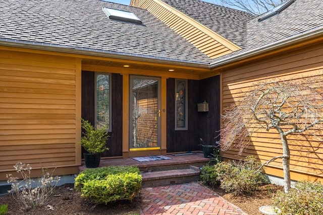 entrance to property with roof with shingles