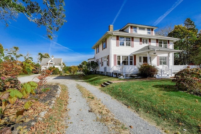 view of property exterior with a lawn and a porch