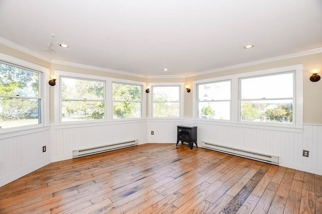 unfurnished sunroom with a baseboard radiator and a wealth of natural light