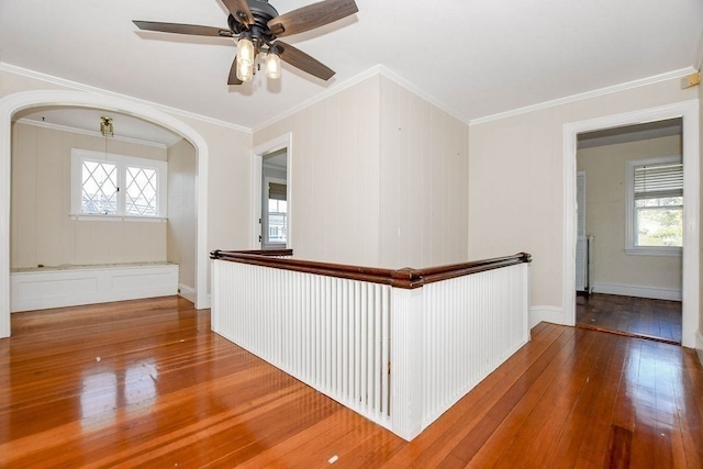 hallway with crown molding and hardwood / wood-style flooring