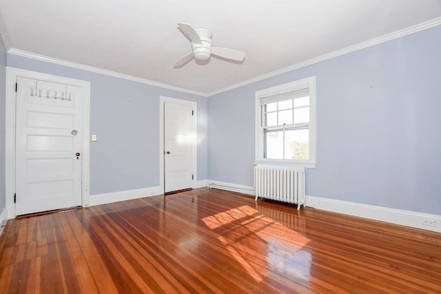 empty room featuring crown molding, radiator heating unit, hardwood / wood-style flooring, and ceiling fan