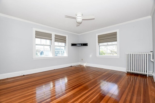 unfurnished room with ornamental molding, radiator heating unit, dark hardwood / wood-style floors, and plenty of natural light