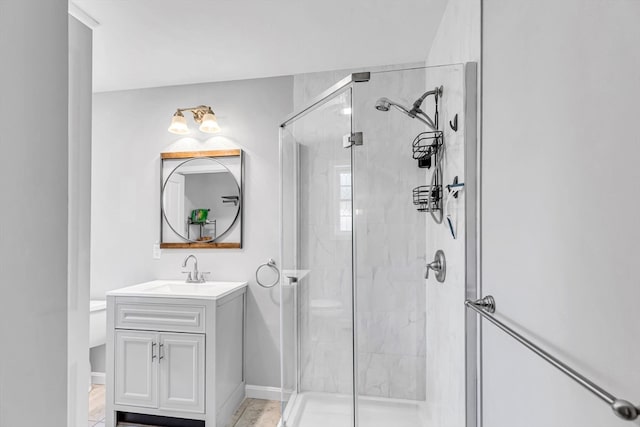 bathroom featuring vanity, toilet, and an enclosed shower