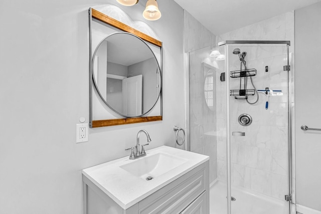 bathroom with vanity and a shower with door