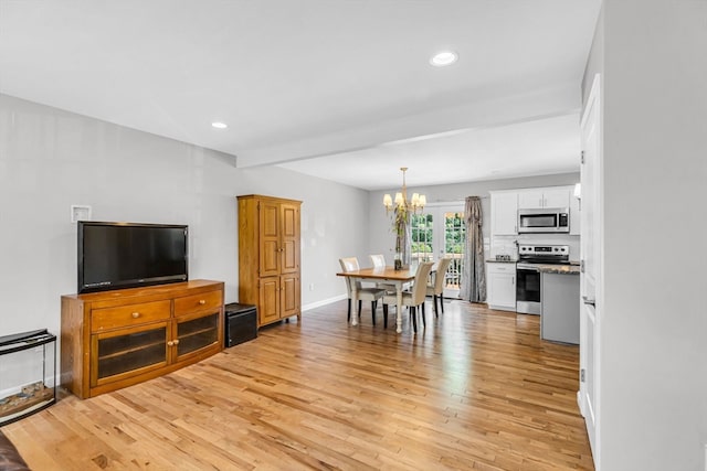 dining room featuring light hardwood / wood-style flooring and a notable chandelier