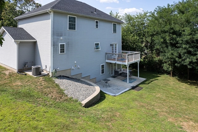 rear view of property with cooling unit, a deck, a yard, and a patio area