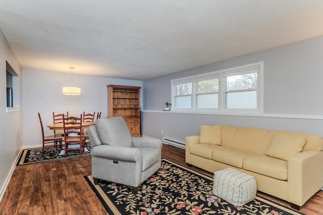 living area featuring baseboards, baseboard heating, and wood finished floors