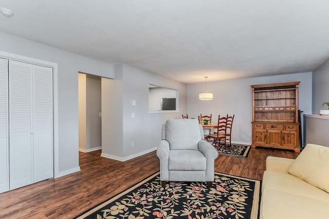 living room featuring baseboards and wood finished floors