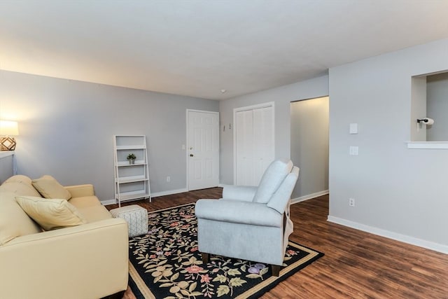 living area with wood finished floors and baseboards