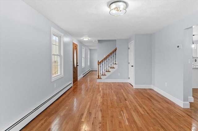 interior space featuring light hardwood / wood-style flooring and a baseboard heating unit