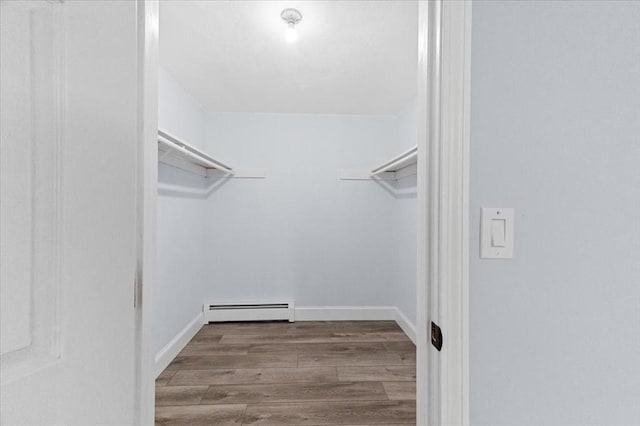 walk in closet with hardwood / wood-style floors and baseboard heating