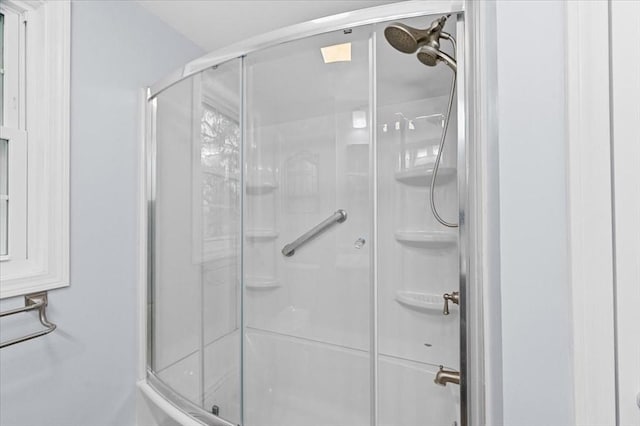 bathroom featuring a shower with shower door