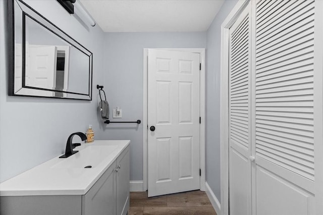 bathroom with hardwood / wood-style floors and vanity