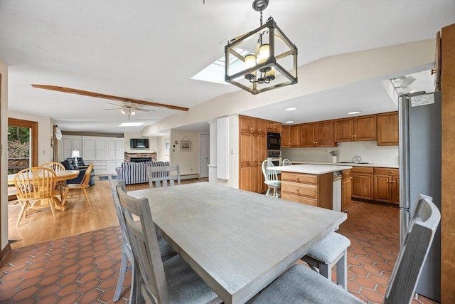 dining space with tile patterned flooring, ceiling fan, a fireplace, and recessed lighting