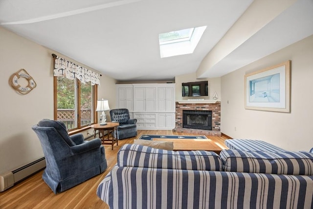 living area featuring a skylight, wood finished floors, baseboard heating, a fireplace, and a baseboard radiator