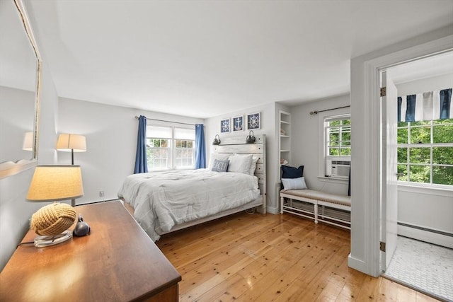 bedroom with light wood-style floors and cooling unit