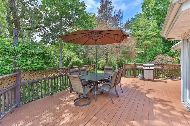 wooden terrace featuring grilling area and outdoor dining area