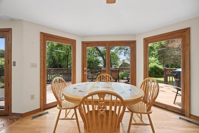 dining area featuring baseboards and light wood finished floors