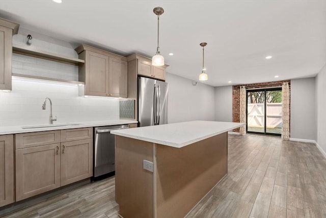 kitchen featuring light countertops, appliances with stainless steel finishes, open shelves, a kitchen island, and a sink