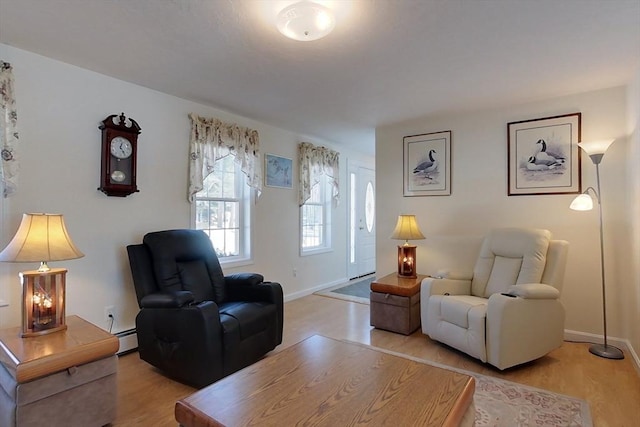 living room with light wood-style flooring, baseboards, and baseboard heating