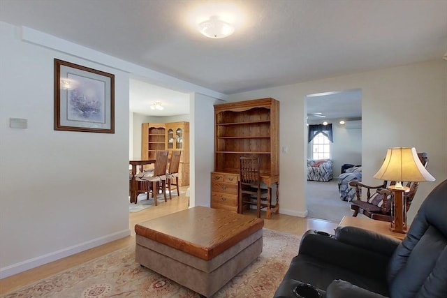 living room featuring baseboards and light wood-style floors