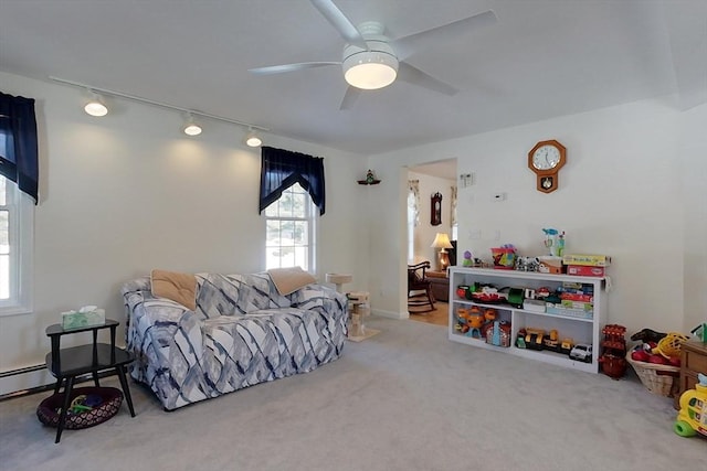 carpeted living area featuring ceiling fan and track lighting