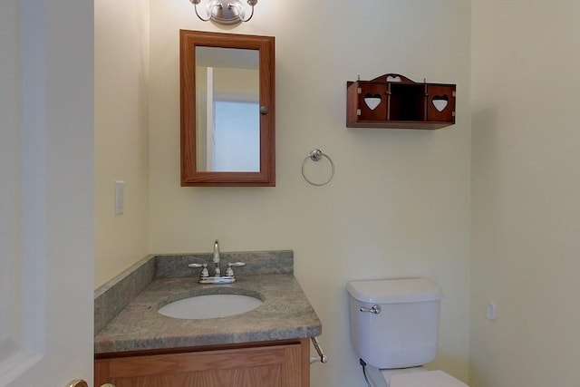 bathroom featuring toilet and vanity