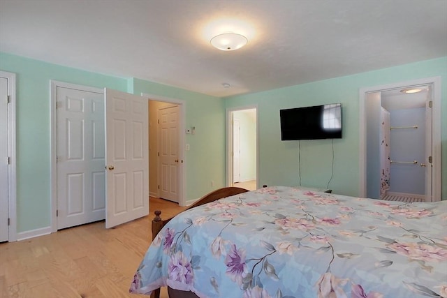 bedroom with baseboards and light wood finished floors