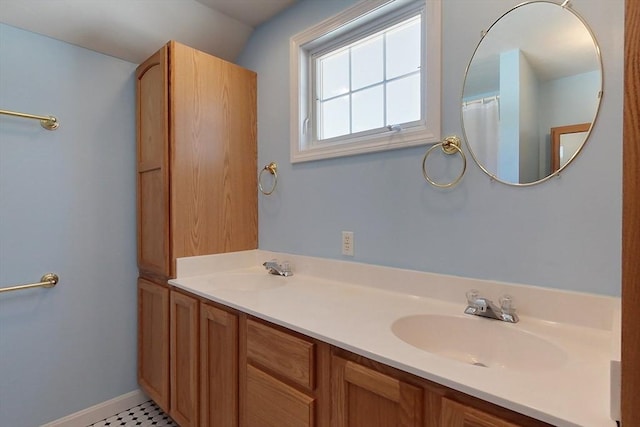 bathroom featuring a sink and double vanity