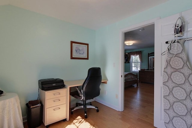 office featuring light wood-style flooring and baseboards