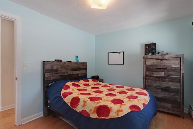 bedroom with wood finished floors and baseboards