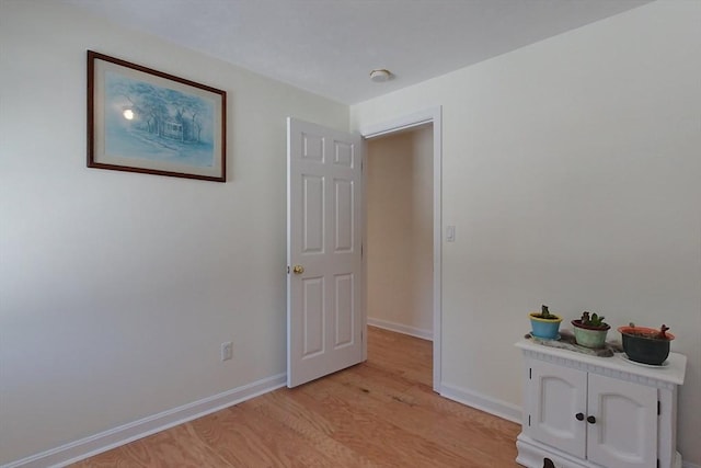 interior space featuring light wood-style flooring and baseboards