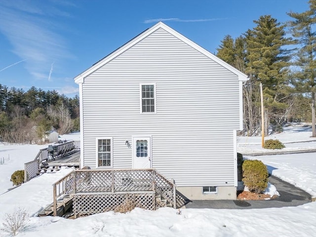 view of snowy exterior with a deck