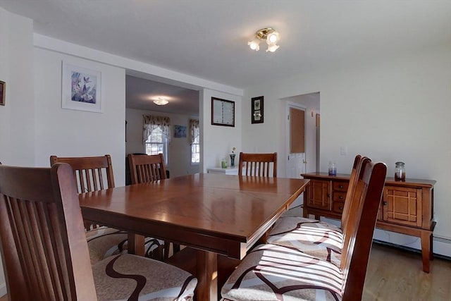 dining space featuring light wood-style flooring