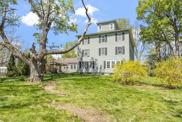 back of property featuring a yard