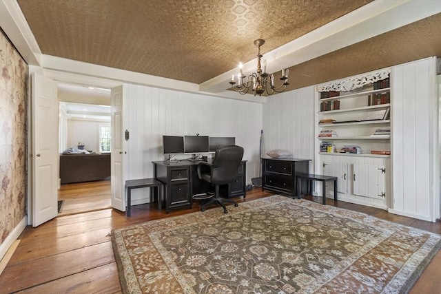 office space with an ornate ceiling, hardwood / wood-style floors, and a notable chandelier