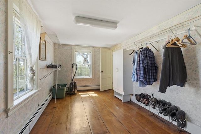 mudroom with baseboard heating and hardwood / wood-style flooring