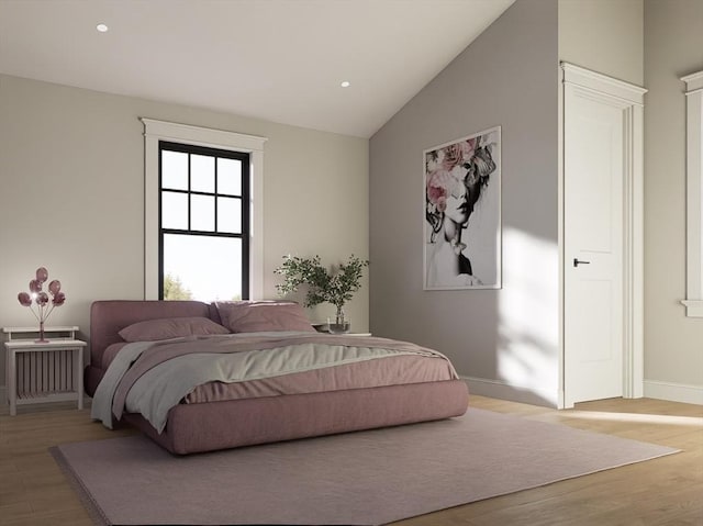 bedroom with hardwood / wood-style floors and lofted ceiling