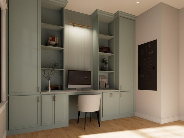 office area featuring light wood-type flooring, built in features, and built in desk