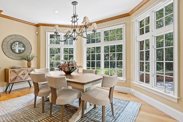 sunroom featuring visible vents and a notable chandelier