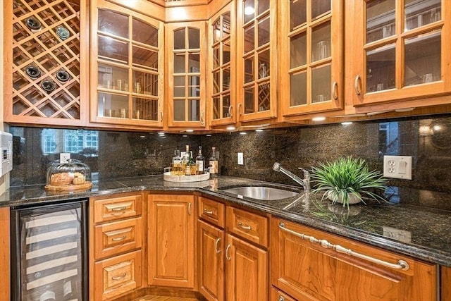 bar featuring wine cooler, decorative backsplash, wet bar, and a sink