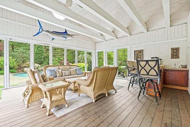 sunroom featuring beamed ceiling