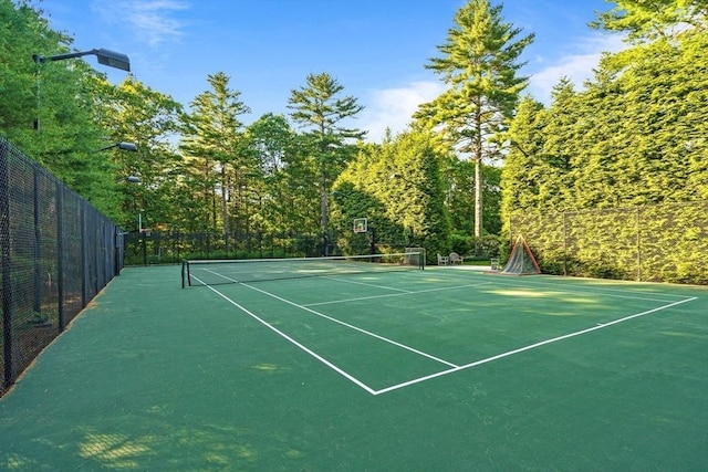 view of tennis court featuring fence