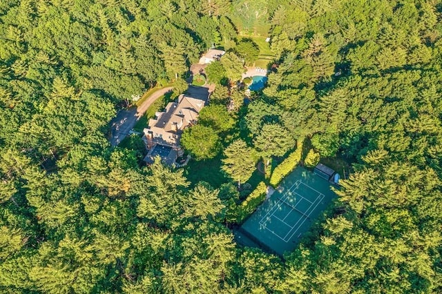 bird's eye view with a wooded view