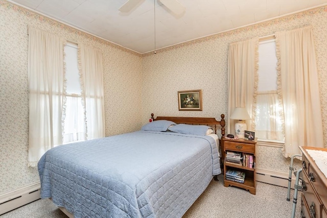 carpeted bedroom with baseboard heating, wallpapered walls, and a ceiling fan